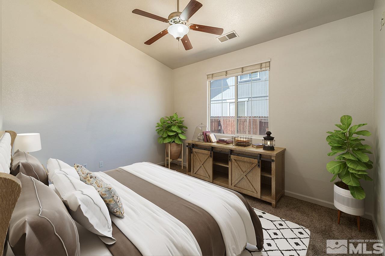 9025 Andraste Way Reno, NV 89506 - Photo 18 of 31 a bedroom with a bed and a potted plant