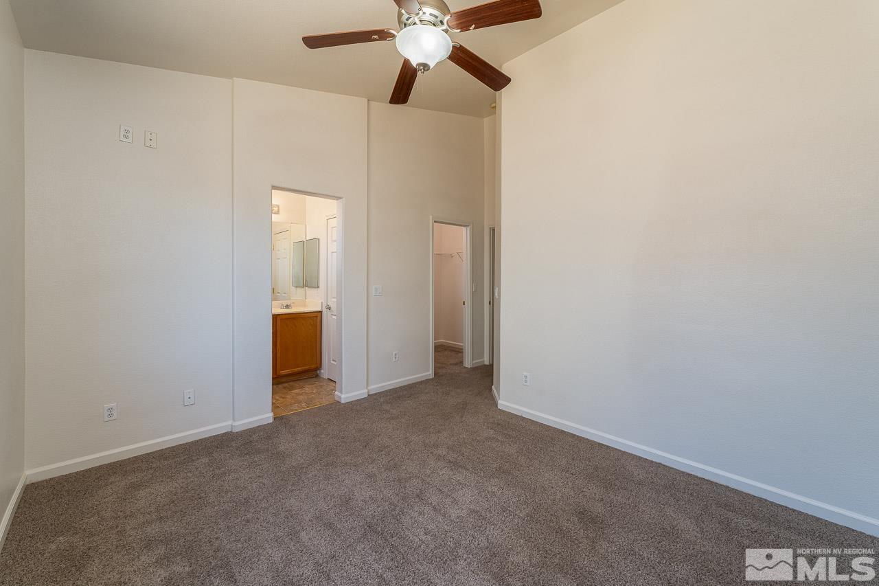 9025 Andraste Way Reno, NV 89506 - Photo 21 of 31 an empty room with closet and a chandelier fan
