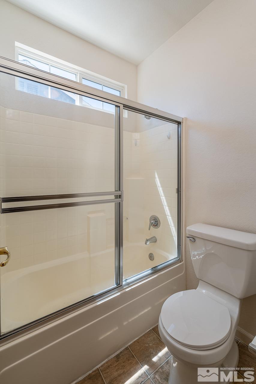 9025 Andraste Way Reno, NV 89506 - Photo 25 of 31 a bathroom with a toilet and a shower