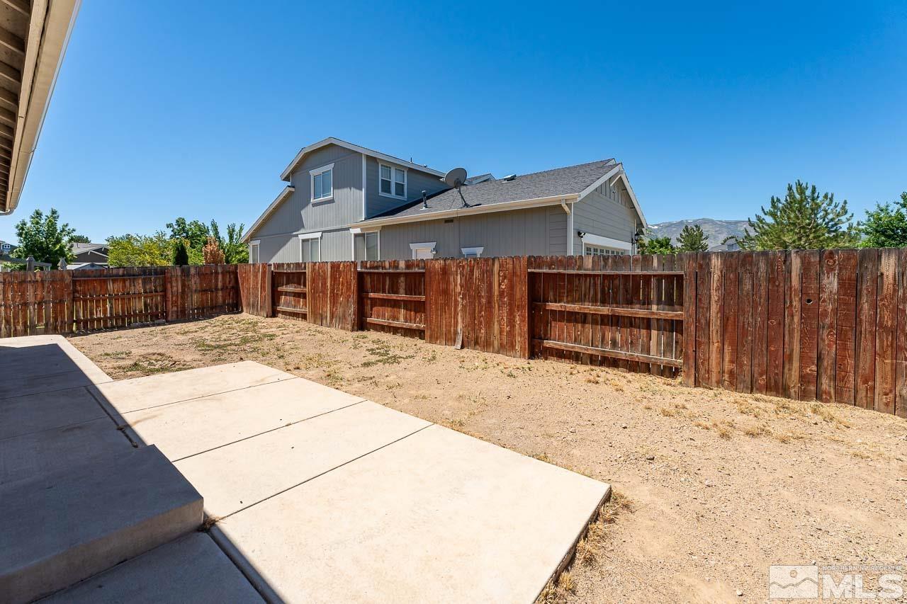 9025 Andraste Way Reno, NV 89506 - Photo 28 of 31 a backyard of a house with wooden fence