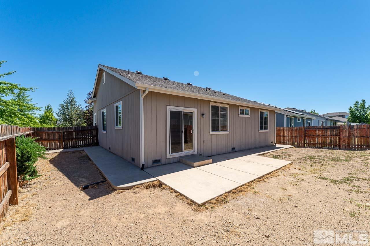 9025 Andraste Way Reno, NV 89506 - Photo 29 of 31 a view of house with backyard and trees in the background