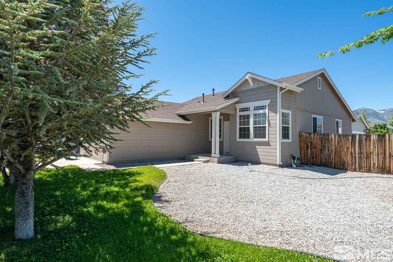9025 Andraste Way Reno, NV 89506 - Photo 3 of 31 a front view of a house with yard and green space