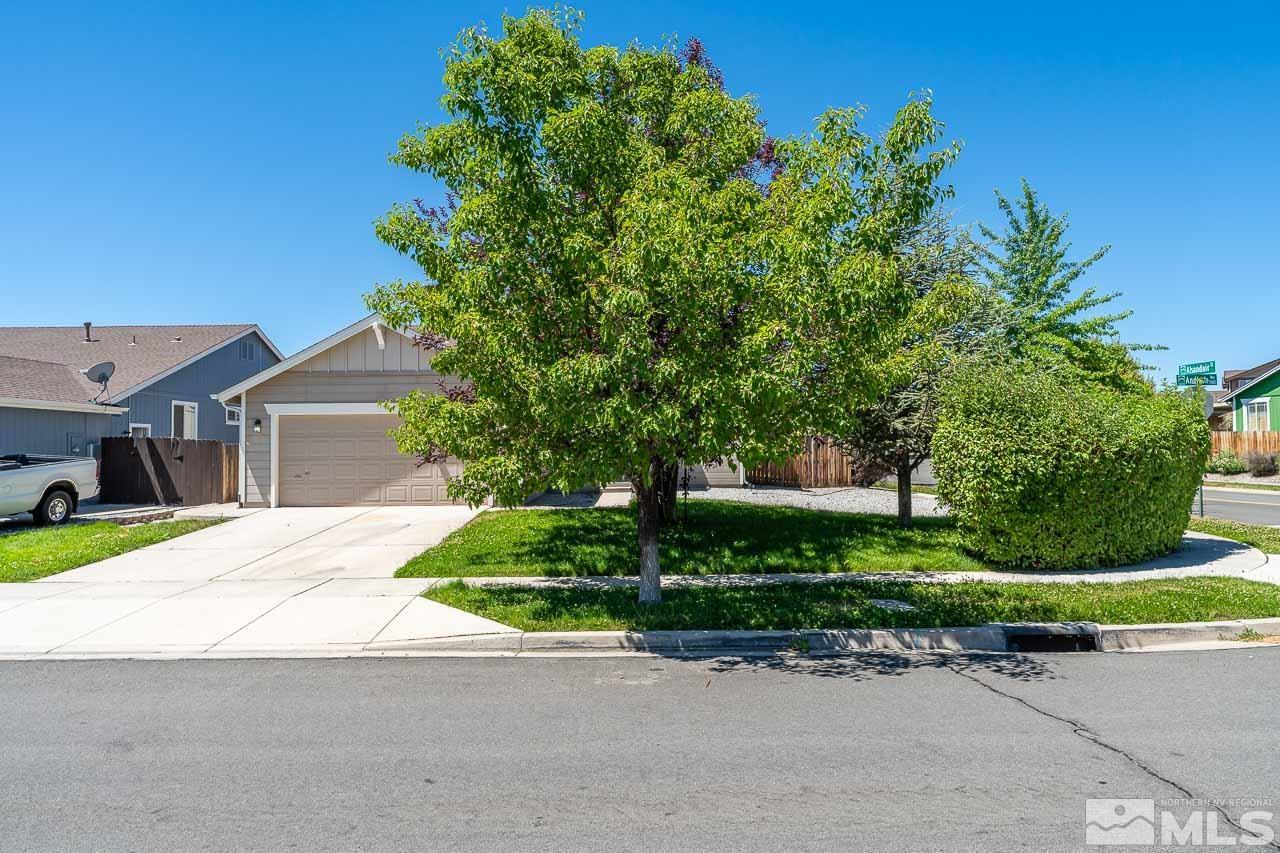 9025 Andraste Way Reno, NV 89506 - Photo 4 of 31 a front view of a house with a yard and a garage