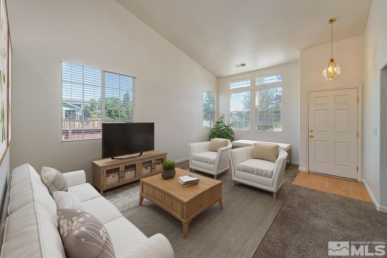 9025 Andraste Way Reno, NV 89506 - Photo 5 of 31 a living room with furniture a window and a flat screen tv