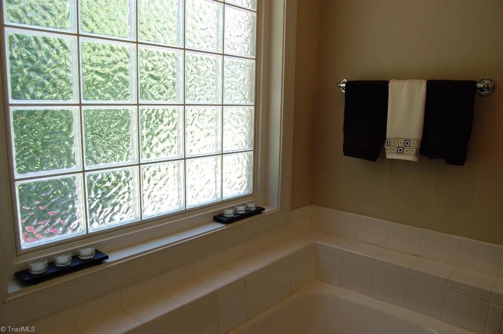1883 South Union Grove Road Lexington, NC 27295 - Photo 18 of 30 Master jetted spa tub with tile accents and glass block window allow for lots of lighting AND privacy. Separate shower for convenience.
