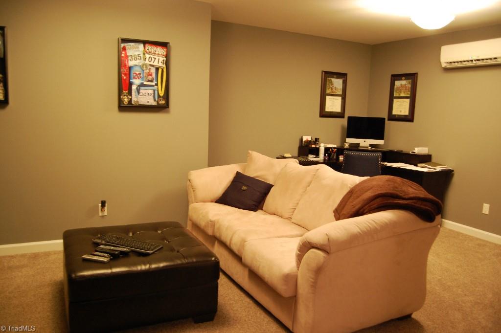 1883 South Union Grove Road Lexington, NC 27295 - Photo 24 of 30 Den area is carpeted and features a great nook for a home office or pool table. Entire finished basement is heated/cooled with ductless unit making your home energy efficient and smart!