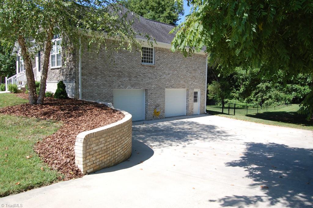 1883 South Union Grove Road Lexington, NC 27295 - Photo 27 of 30 2 car basement garage with separate exterior entry door, retaining wall.