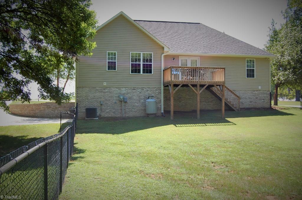 1883 South Union Grove Road Lexington, NC 27295 - Photo 30 of 30 Back view of home from fenced yard. Great deck for entertaining! To the left is driveway entrance and more land unfenced making over an acre total.