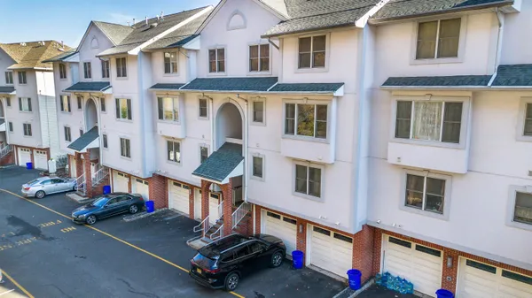 a aerial view of a residential apartment building with a yard