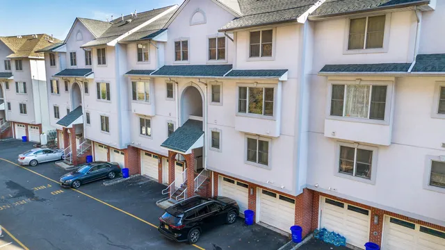a aerial view of a residential apartment building with a yard