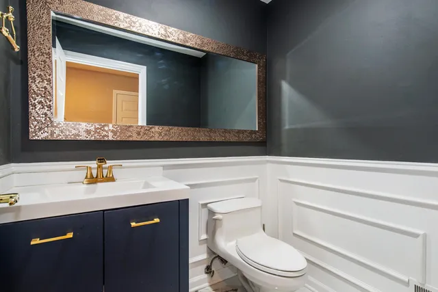 a bathroom with a sink vanity and toilet