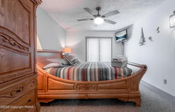 a bathroom with a granite countertop toilet sink and mirror