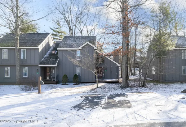 a view of a house with a snow in the yard