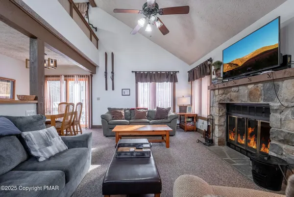 a living room with furniture flat screen tv and a fireplace