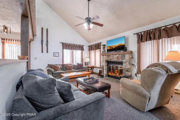a living room with furniture and a fireplace