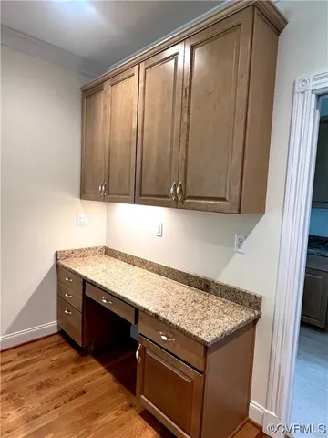 a kitchen with granite countertop cabinets washer and dryer