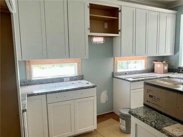 a kitchen with stainless steel appliances granite countertop a sink stove and cabinets