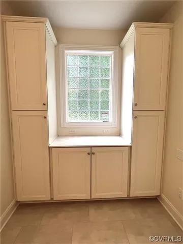 a view of a kitchen with a refrigerator and window