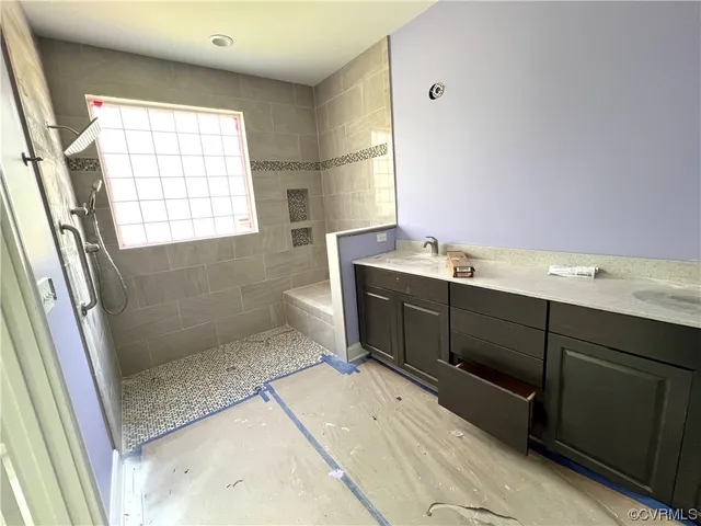 a bathroom with a sink mirror and a bathtub
