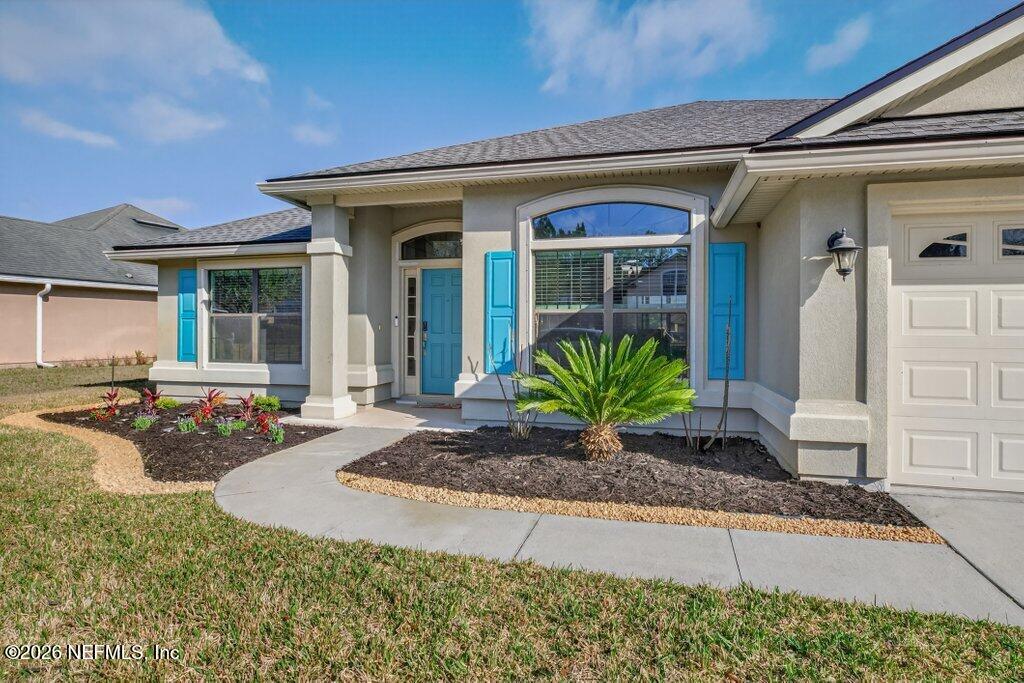 109 Cummer Way St. Augustine, FL 32095 - Photo 3 of 42 a front view of a house with porch and outdoor seating
