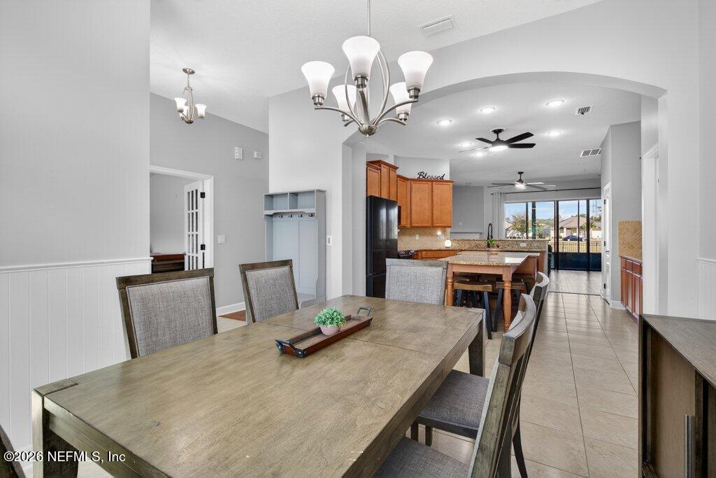 109 Cummer Way St. Augustine, FL 32095 - Photo 10 of 42 a view of a dining room with furniture and a chandelier