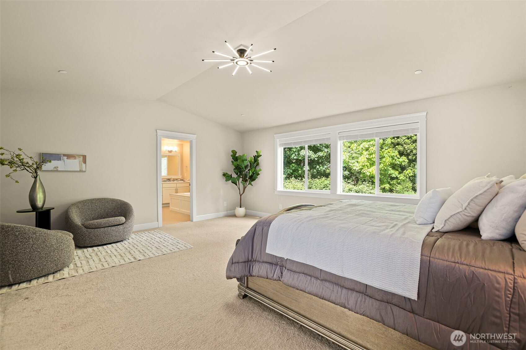29 242nd Street Southeast Bothell, WA 98021 - Photo 18 of 40 a bedroom with a bed and a chandelier