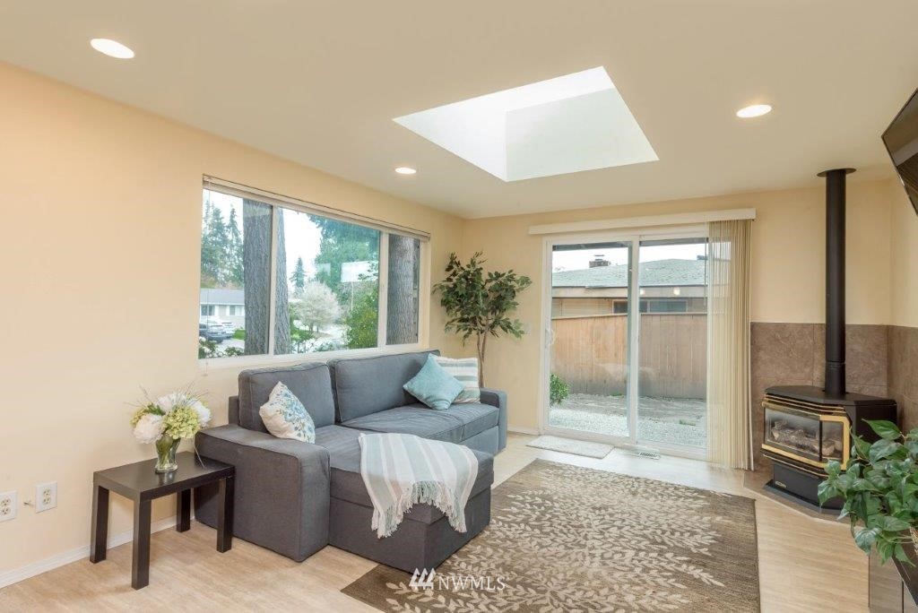 12525 Southeast 99th Street Renton, WA 98056 - Photo 12 of 33 a living room with furniture and a floor to ceiling window