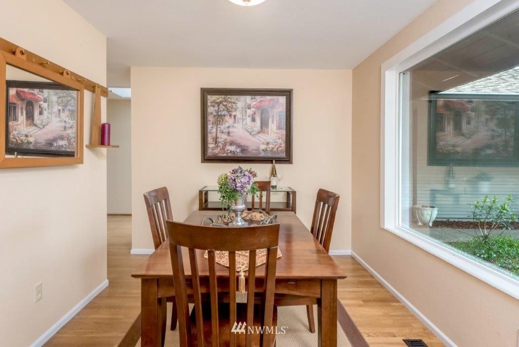 12525 Southeast 99th Street Renton, WA 98056 - Photo 15 of 33 a view of a dining room with furniture and wooden floor