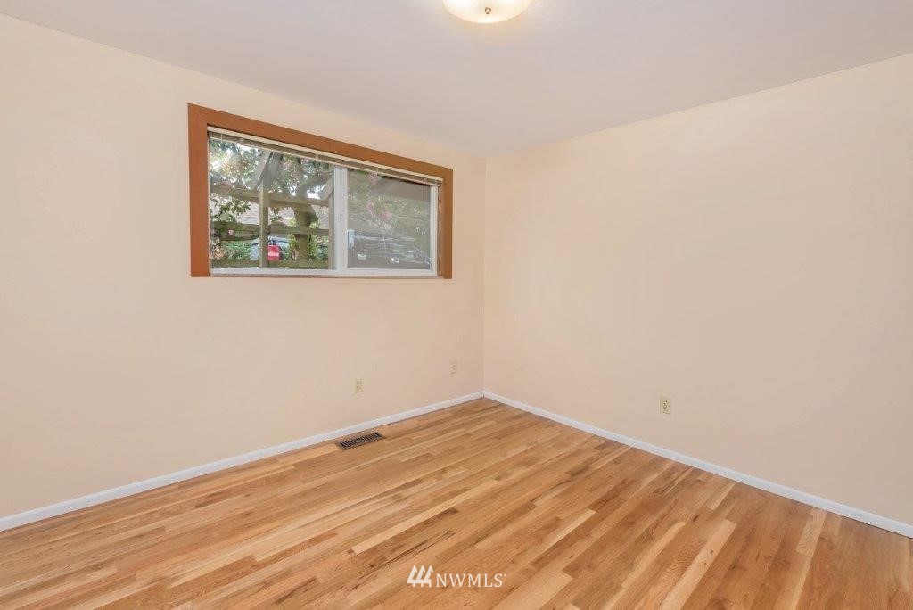 12525 Southeast 99th Street Renton, WA 98056 - Photo 21 of 33 an empty room with wooden floor and window