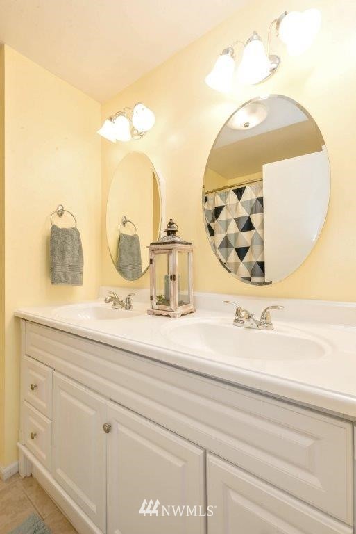 12525 Southeast 99th Street Renton, WA 98056 - Photo 23 of 33 a bathroom with a sink and mirror