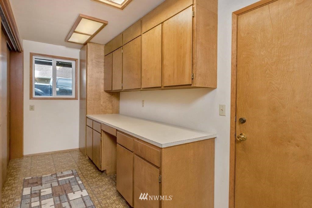 12525 Southeast 99th Street Renton, WA 98056 - Photo 25 of 33 a kitchen with a sink and a refrigerator