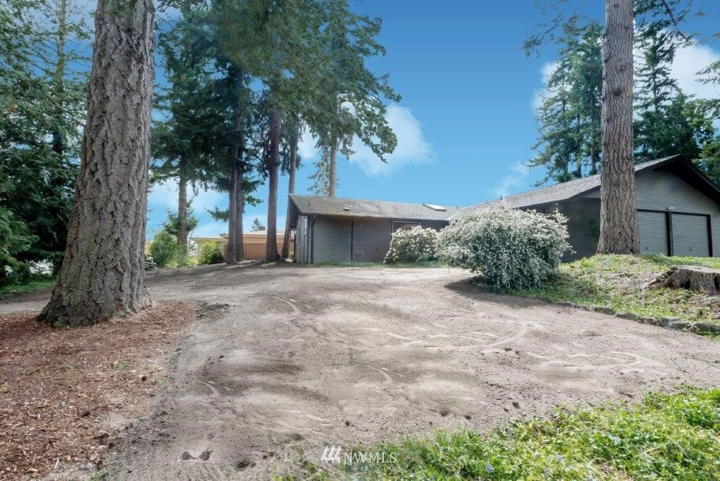12525 Southeast 99th Street Renton, WA 98056 - Photo 26 of 33 a view of a house with a tree and a yard
