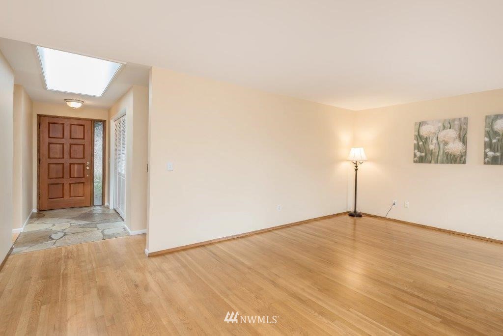 12525 Southeast 99th Street Renton, WA 98056 - Photo 5 of 33 a view of an empty room with wooden floor and a window