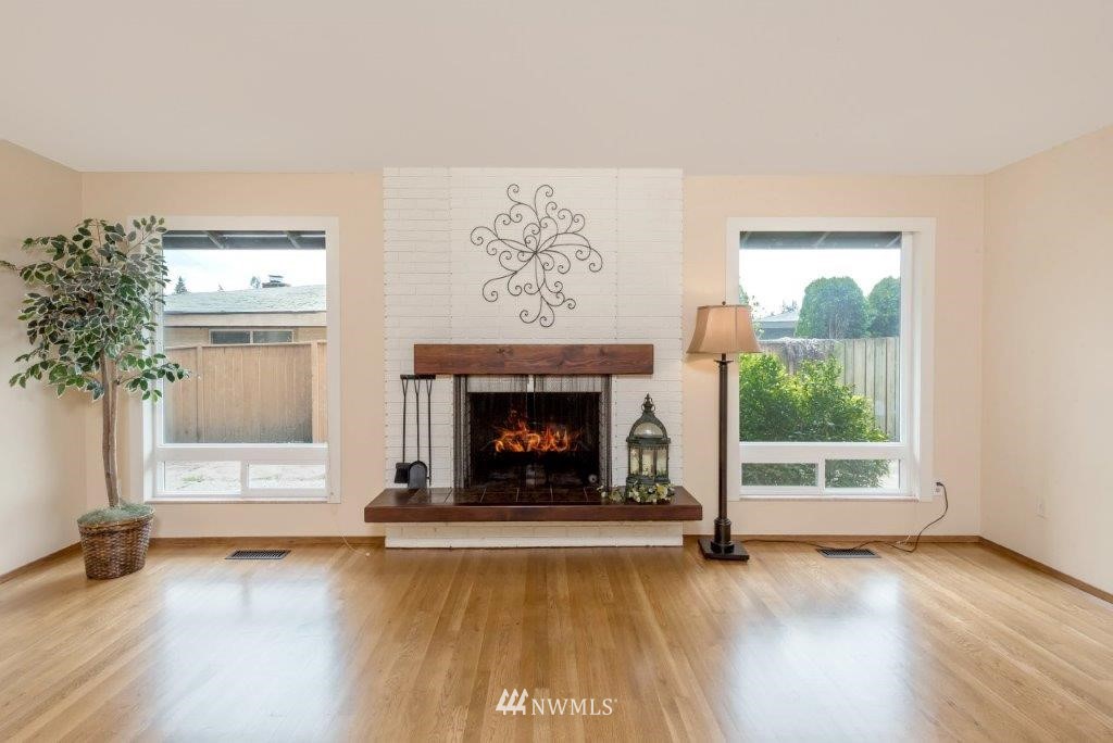 12525 Southeast 99th Street Renton, WA 98056 - Photo 7 of 33 a living room with a fireplace with wooden floor