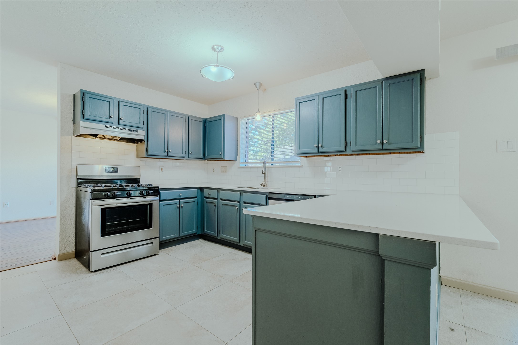 17030 Kirkchapel Street Spring, TX 77379 - Photo 11 of 28 a kitchen with a stove and a refrigerator