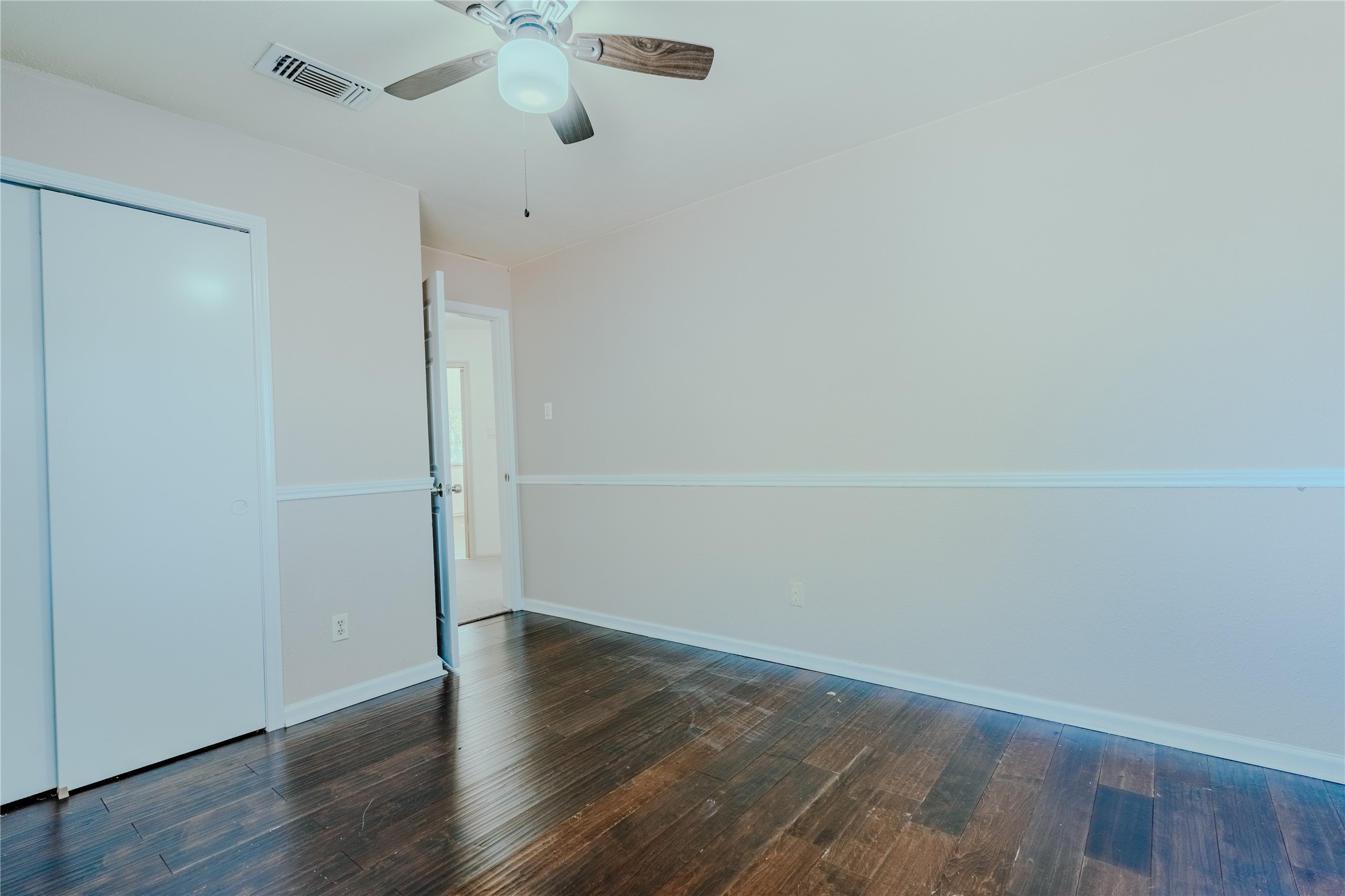 17030 Kirkchapel Street Spring, TX 77379 - Photo 22 of 28 an empty room with wooden floor and fan