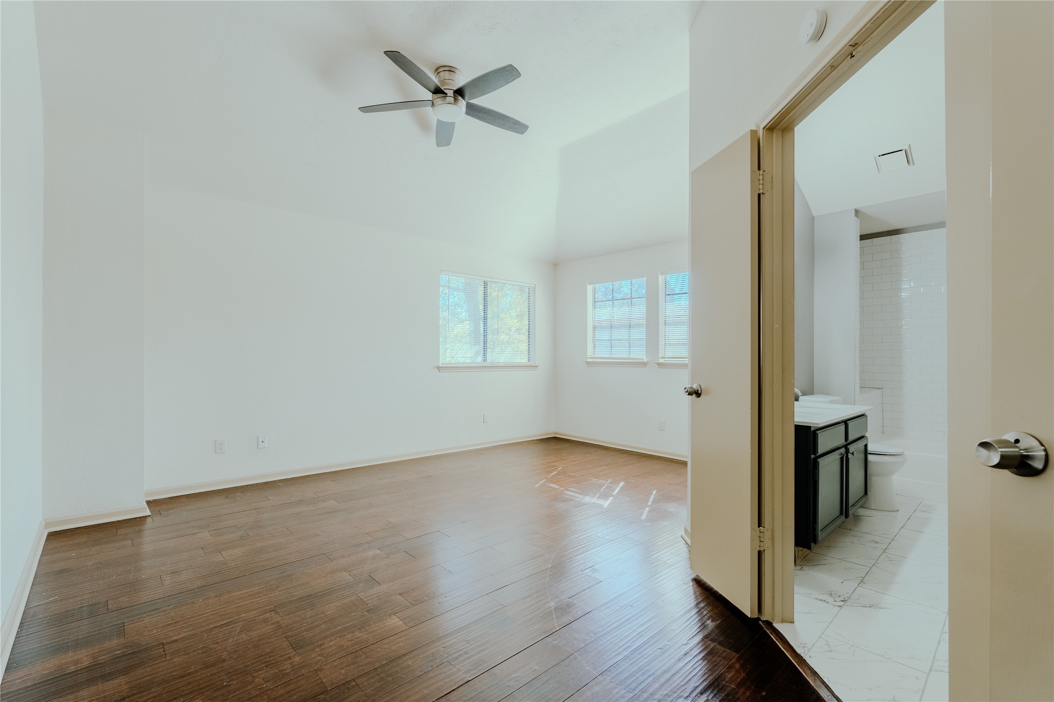 17030 Kirkchapel Street Spring, TX 77379 - Photo 24 of 28 an empty room with wooden floor and windows