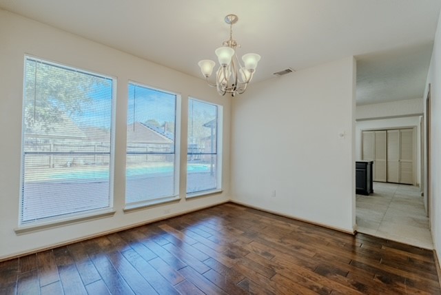 17030 Kirkchapel Street Spring, TX 77379 - Photo 8 of 28 a view of an empty room with wooden floor and a window