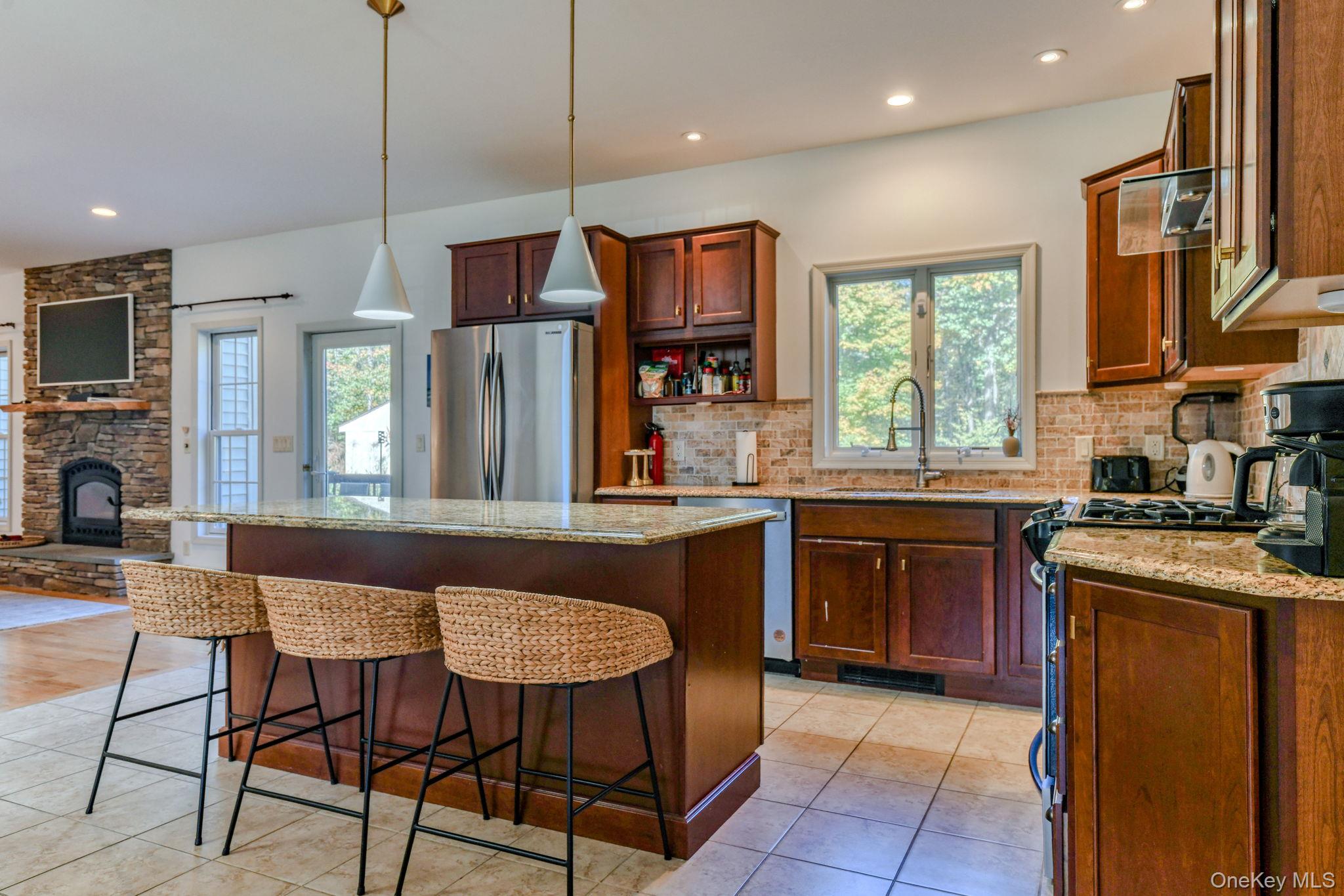 54 Borden Road Walden, NY 12586 - Photo 11 of 46 a kitchen with stainless steel appliances granite countertop a stove a sink a oven a refrigerator with a dining table and chairs