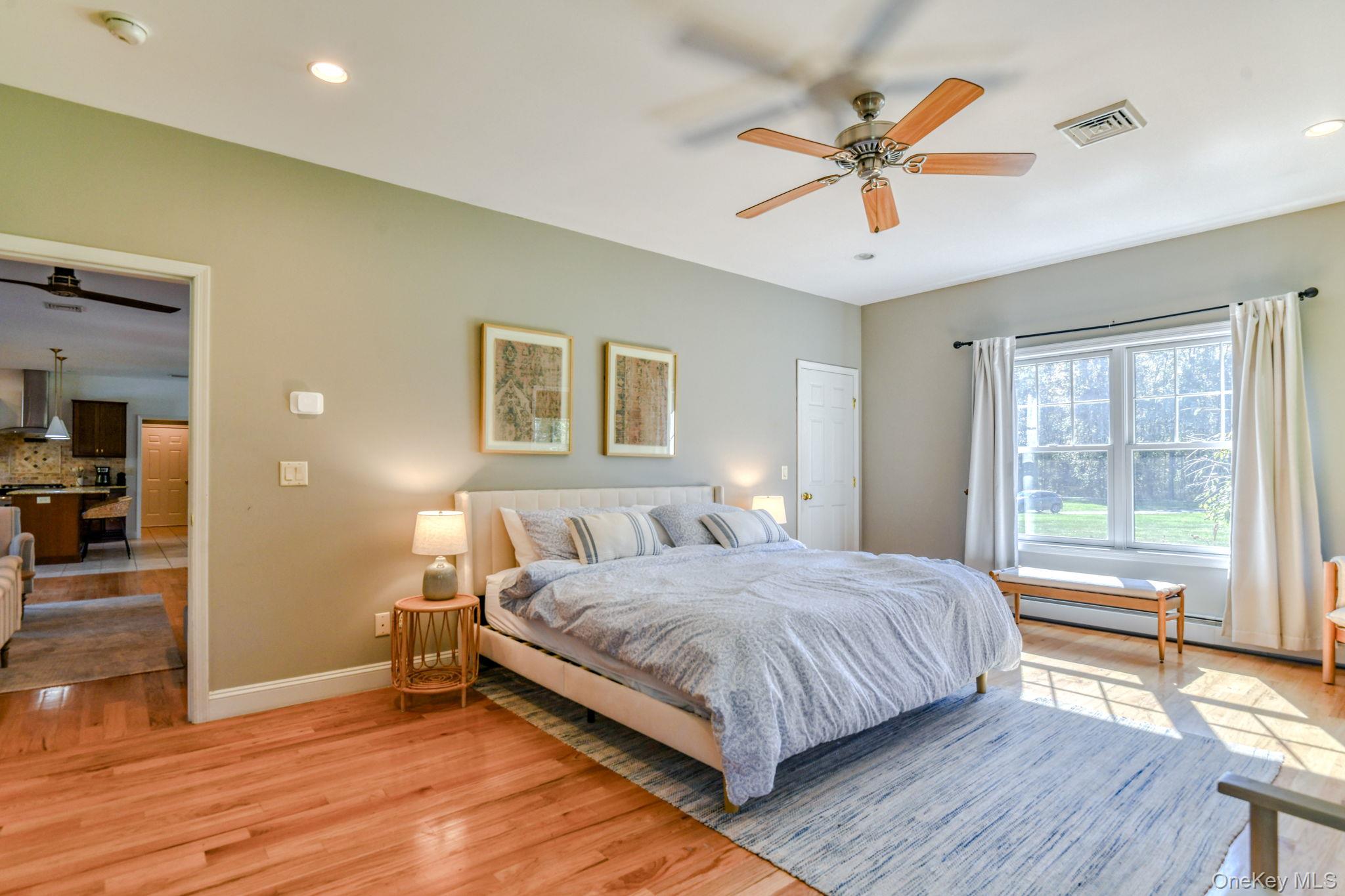 54 Borden Road Walden, NY 12586 - Photo 17 of 46 a bedroom with a bed and a large window with wooden floor