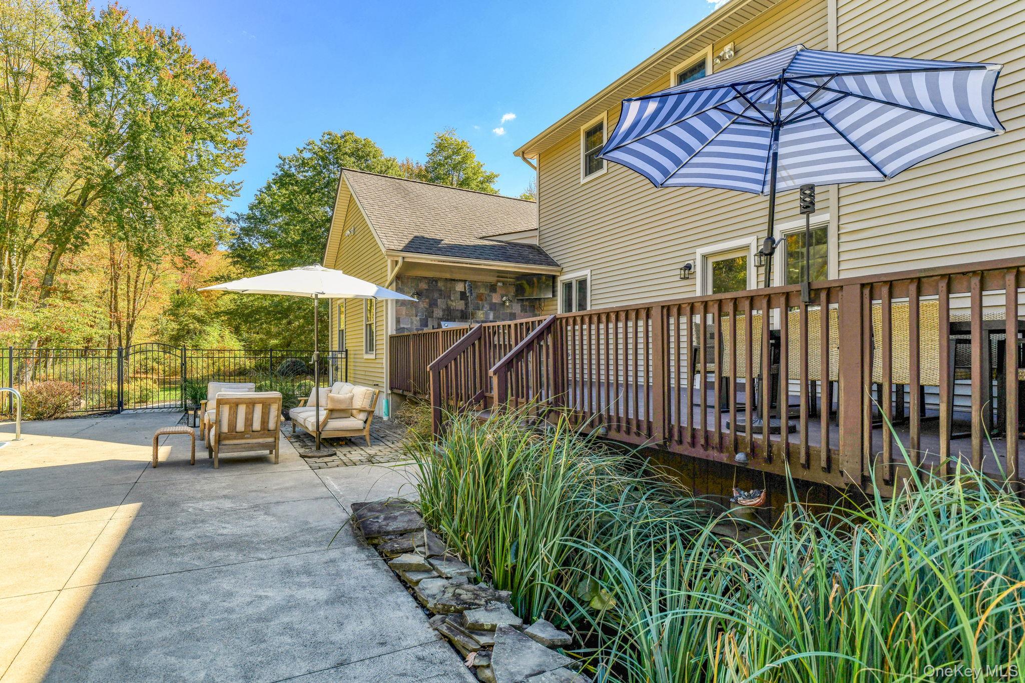 54 Borden Road Walden, NY 12586 - Photo 31 of 46 a view of a patio with a table and chairs under an umbrella