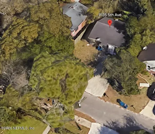 an aerial view of residential houses with outdoor space