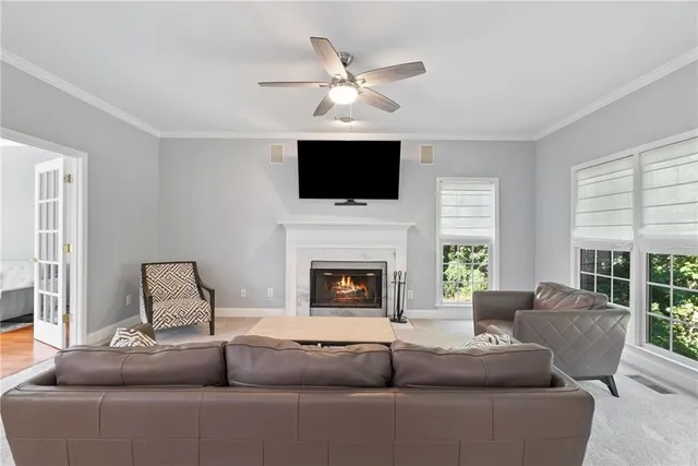a living room with furniture a fireplace and a flat screen tv