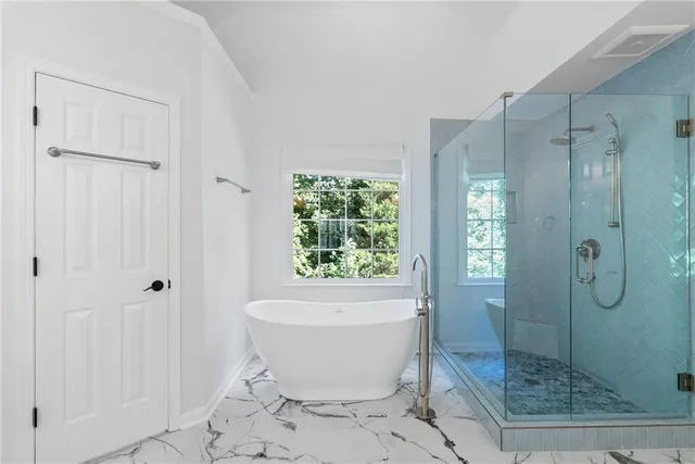 a spacious bathroom with a granite countertop sink a toilet a mirror and vanity