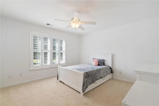 a spacious bedroom with a bed and a window