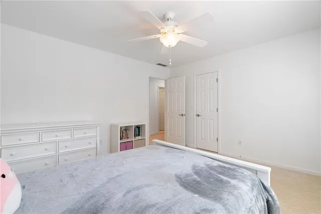 a bathroom with a double vanity sink a shower and a mirror