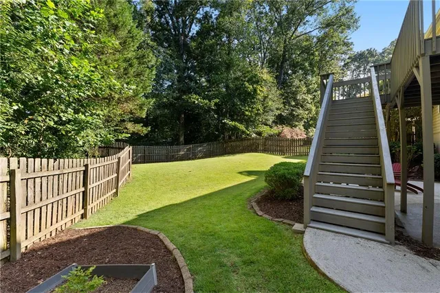 an aerial view of a house with a yard and garden