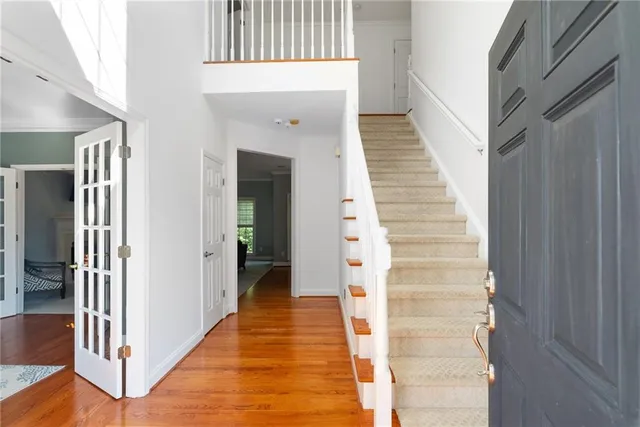 a view of a hallway with wooden floor and entryway