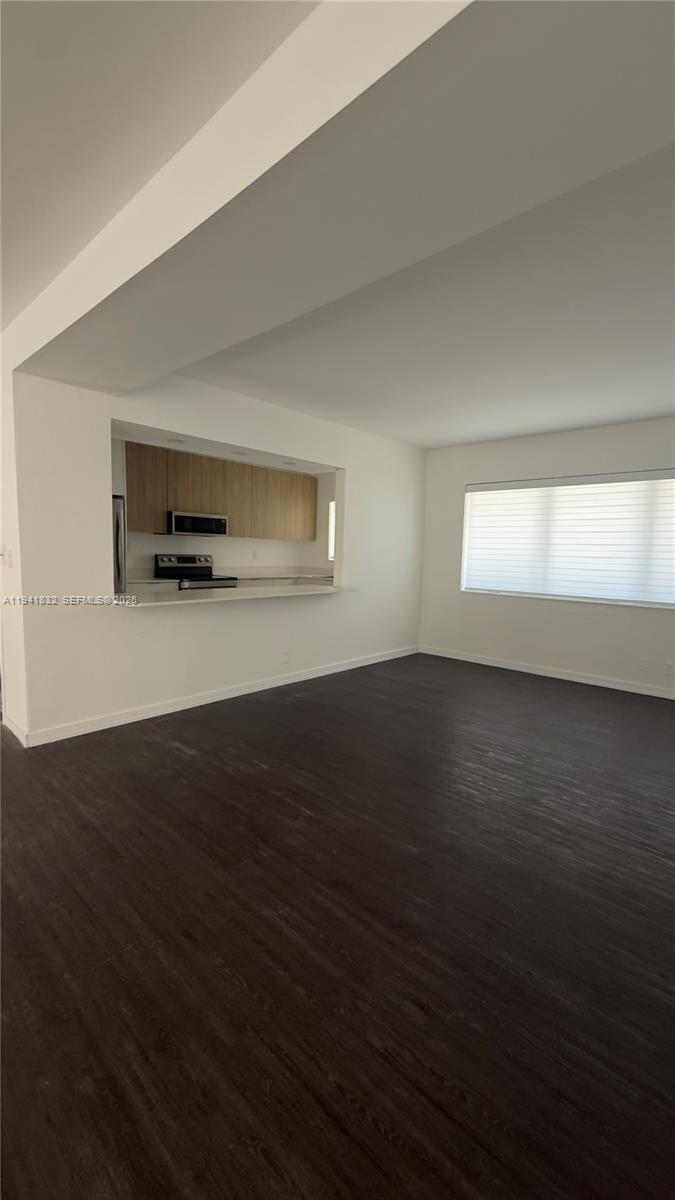 2000 Southwest 13th Court Miami, FL 33145 - Photo 11 of 22 a view of empty room with wooden floor and fan