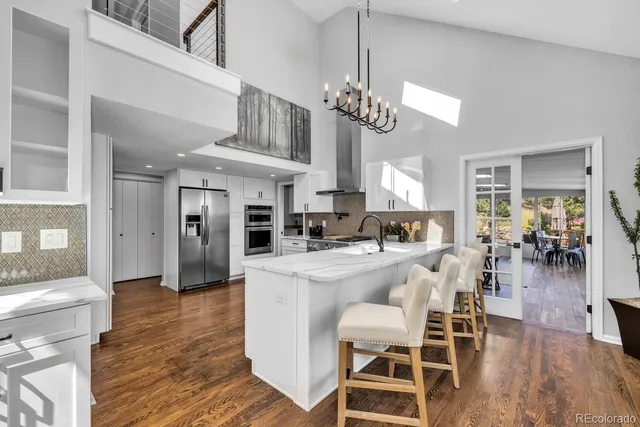 a view of a dining room with furniture wooden floor and chandelier